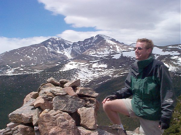 Steve on the summit admiring the view of the Twin Sisters with Long's Peak in the background.