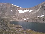 As there is no longer a trail to follow, a route to the top was chosen by going around the south side of this lake (12,695 feet) and up through the dry spot in the snow covered saddle.